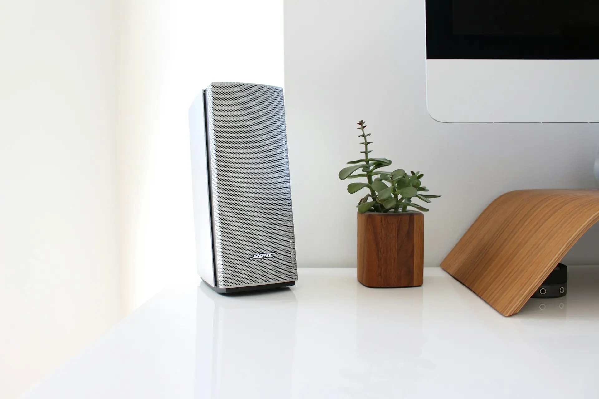 gray speaker on table near brown wooden pto